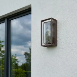 Aplique de exterior Arcchio Ismera, color óxido, IP65, cristal, E27