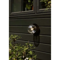 Aplique de exterior Nuura Liila, Ø 16 cm, negro/transparente
