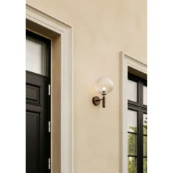 Aplique para exterior Nuura Miira, Ø 20 cm, bronce oscuro/transparente