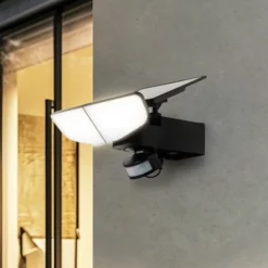 Aplique solar LED Lindby Naelin, negro, sensor, IP44