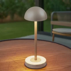 Lámpara de mesa LED recargable Lindby Pippin, dorada/travertino, IP44