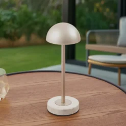 Lámpara de mesa LED recargable Lindby Pippin, dorada/travertino, IP44