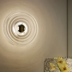 Tom Dixon Aplique de pared LED Press Mini, transparente, 21 cm, IP55